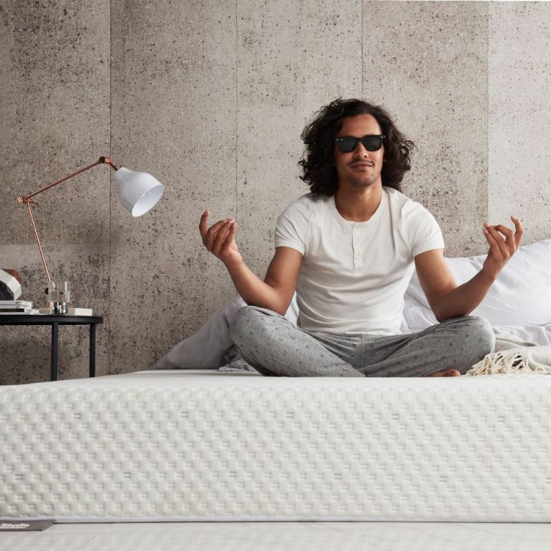 Man Sitting on the bed in Cross-legged Yoga Position